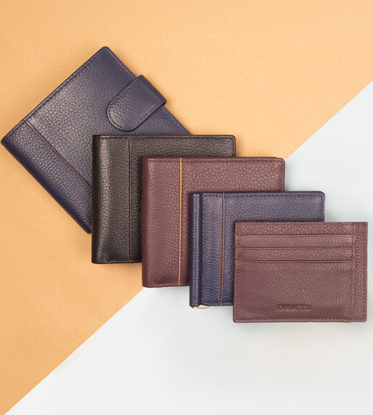 Men's leather wallets in various colours and styles laid out in our two coloured background